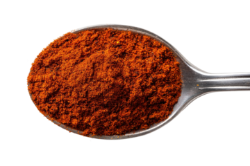 Red spice powder fills a metal spoon
