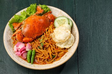 Kepiting Mie Aceh. Aceh Noodle Crab is a typical food from the Aceh region which is usually noodles with strong curry spices and combined with crab