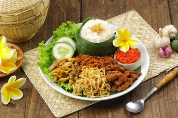 Nasi jinggo is a typical Balinese dish consisting of small portions of white rice wrapped in banana...