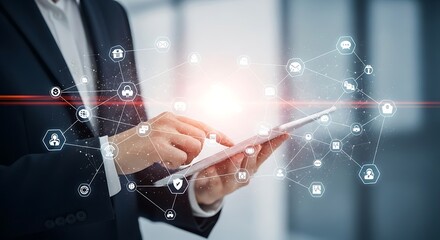 Business professional using a tablet with glowing network connections and digital icons emerging