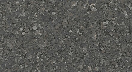 A closeup of a dark gray speckled surface with crystalline inclusions resembling granite