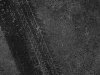 Close up black tire marks on cement floor.