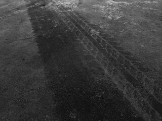 Close up black tire marks on cement floor.