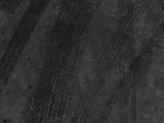 Close up black tire marks on cement floor.