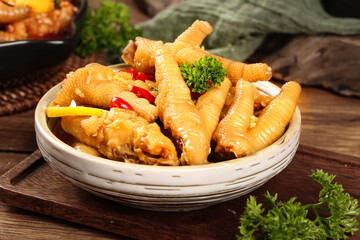 Hot Spicy Chicken Feet Claws with Peppers and Lemon Asian Cuisine Appetizer in Bamboo Basket