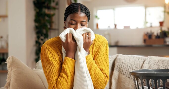 Fototapeta Relax, aroma and woman in home with laundry, housekeeping or fresh scent in spring clean. Happy, comfort and person in living room with material, domestic chores and smell of fabric softener.