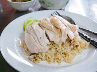 Hainanese Chicken Rice Served on Table in Restaurant. Asian Traditional Food.