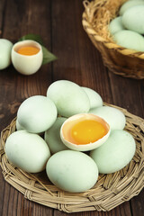 Fresh Green Duck Eggs with Golden Yolks in Wicker Baskets on Wooden Table - Farm Fresh Organic Poultry Products