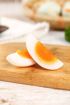 Fresh Hard-Boiled Egg Slices with Orange Yolk on Bamboo Cutting Board - Healthy Breakfast Ingredient
