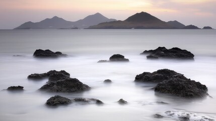 Ethereal Seascape: Rocky Outcrops in Misty Waters at Sunset, Long Exposure