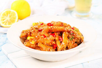 Spicy Marinated Chicken Feet with Red Peppers and Fresh Herbs in White Bowl