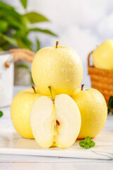 Fresh Yellow Fuji Apples with Mint on White Marble Kitchen Counter