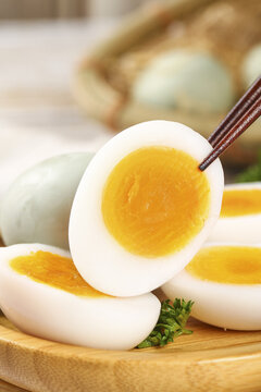 Fresh Hard-Boiled Eggs with Golden Yolks and Clear Whites on Wooden Board