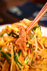 Homemade Asian Stir-Fry with Bean Sprouts and Vermicelli Noodles on Chopsticks