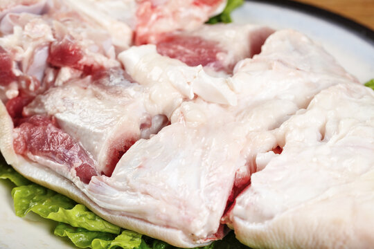 Raw Pork Cuts with Fat Marbling on White Plate Ready for Cooking