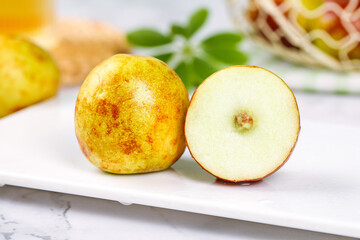 Fresh Chinese Jujube Dates with Cross Section Showing Interior on White Marble Surface