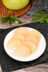 Fresh Sweet Pomelo Segments on Plate with Whole Fruit - Juicy Tropical Citrus