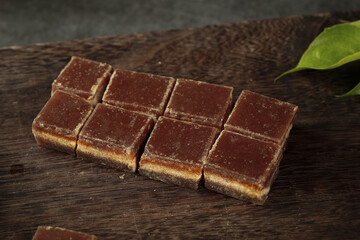 Handmade Brown Sugar Blocks from Guangxi China Traditional Sugarcane Processing Display on Wood Surface