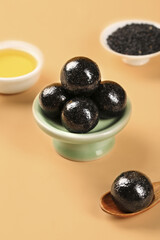 Handmade Black Sesame Seed Pills with Oil and Raw Seeds Closeup