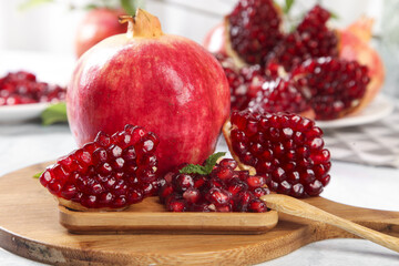 Fresh Tunisian Pomegranate with Red Arils on Wooden Board - Healthy Organic Fruit