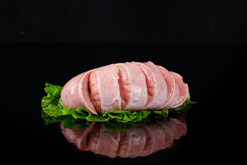 Fresh Sliced Pork Loin with Lettuce on Black Background - Raw Meat Ingredients for Cooking
