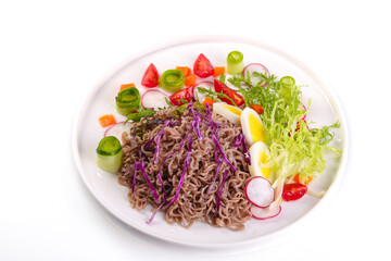 Fresh Mixed Vegetable Salad with Buckwheat Noodles and Boiled Egg on White Plate