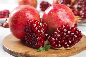 Fresh Large Tunisian Pomegranates with Red Arils on Wooden Board - Healthy Organic Fruit