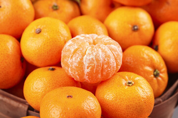 Fresh Seedless Tangerines from Guangxi Sihui Region in Basket Display with Peeled Citrus Segments