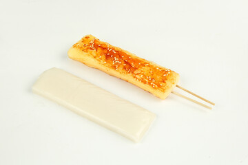 Grilled Rice Cake Skewer with Sweet Glaze and Sesame Seeds on White Background