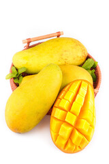 Fresh Golden Mangoes in Wicker Basket with Diced Mango on White Background