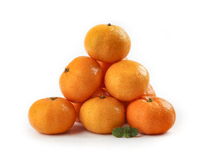 Fresh Orange Tangerines Stacked in Pyramid with Mint Leaf on White Background