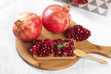 Fresh Pomegranate Fruit with Red Seeds on Wooden Board - Healthy Organic Food