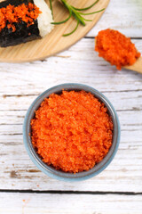 Korean Fish Roe Cuisine with Sushi Rolls and Traditional Asian Food Ingredients on Wooden Background