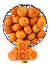 Fresh Small Oranges in Wire Basket with Citrus Slices on White Background