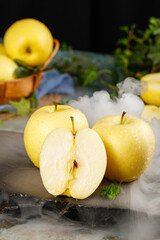 Fresh Yellow Apples Cut in Half on Marble Surface with Mint Garnish