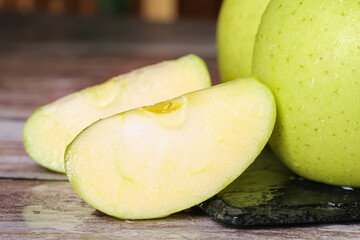 Fresh Green Aomori Apples Sliced on Wood - Sweet Imported Japanese Fruit with Natural Freckled Skin