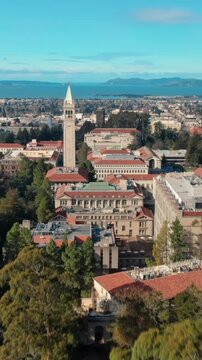 Aerial view of UC Berkeley's iconic Campanile clock tower and campus buildings, showcasing the university's architecture and urban setting in California, USA.