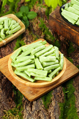 Fresh Green Beans in Wooden Bowls on Natural Rustic Surface with Moss