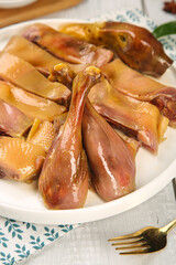 Air-dried cured duck slices on plate - whole handmade traditional delicacy set ready to serve