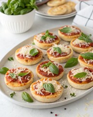 Oval Platter of Mini Pizzas with Tomato Sauce, Cheese, and Basil