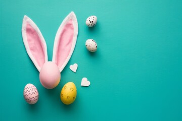 Colorful Easter decorations featuring bunny ears and decorated eggs on a vibrant background