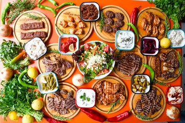 Delicious meat kebab with fresh vegetable salad served with variety of Turkish dishes and...