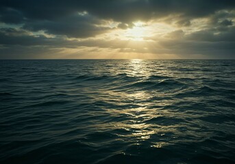 Obraz premium Dramatic Ocean Sunset Golden Light Piercing Through Stormy Clouds Over Dark Water.