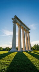 Obraz premium Classical columns under a sunny sky in a park with lush green grass