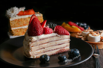 Assortment of fine French pastries, with a dark background, foods high in sugars and carbohydrates that produce fatty liver and other diseases when consumed in high quantities. Horizontal