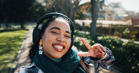 Headphones, peace sign and selfie with girl student on campus for development or education. Emoji,...