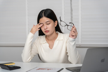 Eye problems, Asian women with tired and irritated eyes, eye rubbing, dry, eye pain after work, migraine, headache, blurred vision, photophobia, working in the dark, blue light from computer