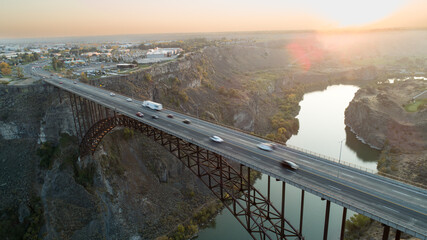 A bridge spans a river with cars driving on it