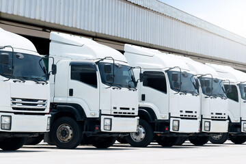 Semi Trailer Trucks on The Parking Lot at  Warehouse. Shipping Cargo Container. Trucks Loading Goods at Dock Warehouse. Distribution Warehouse. Big rig. Freight Logistics Truck Transport	