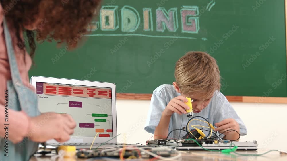 Poster caucasian smart boy fixing main board by using screwdriver at stem technology lesson while smiling s